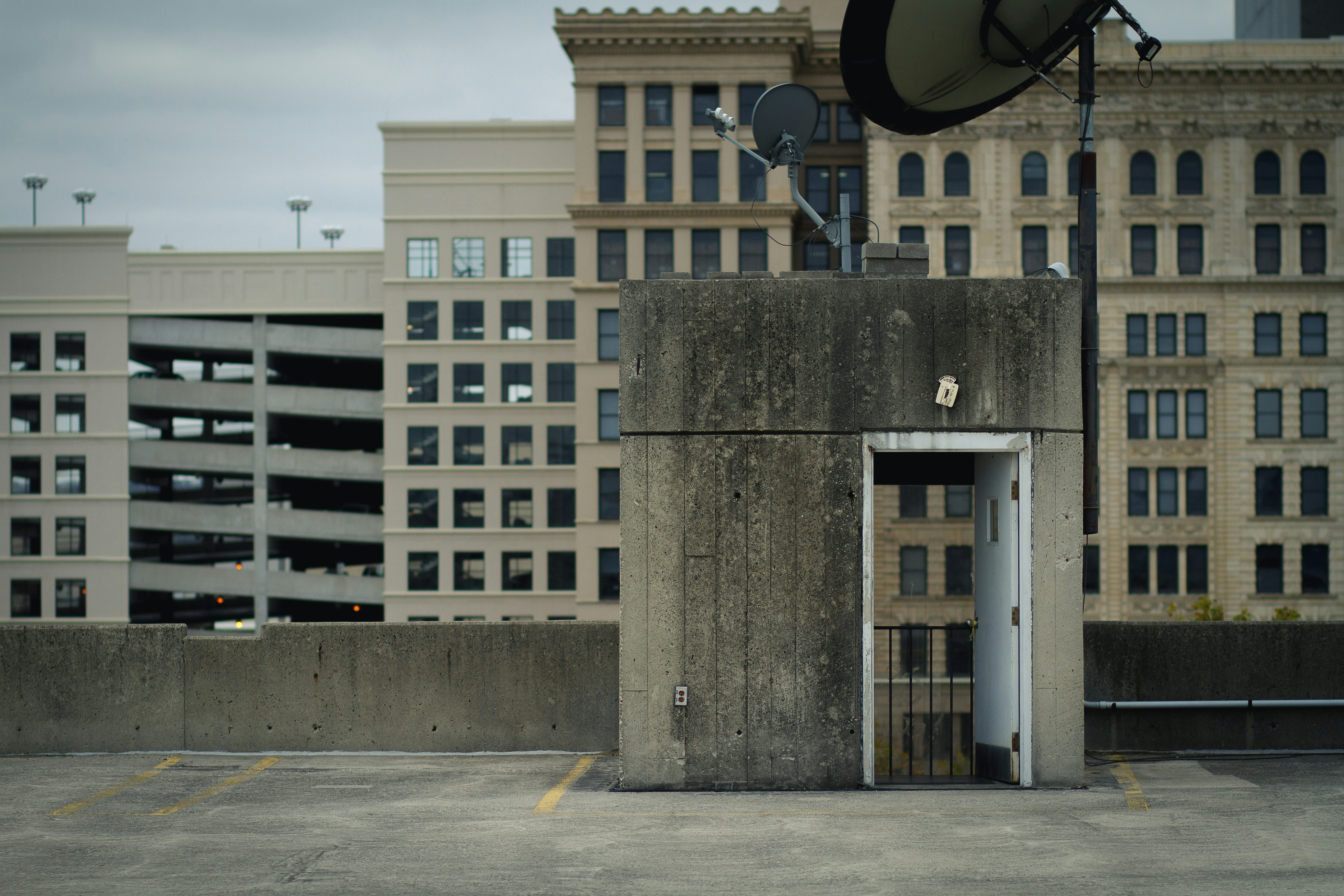 gray concrete house surrounded with buildings